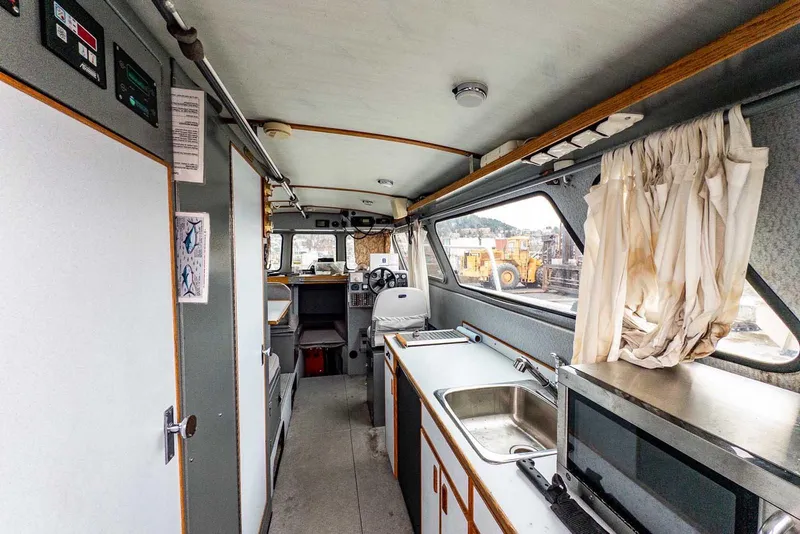 Slide: The Image of Interior of a 2003 Lifetimer 3050 Pleasure Cabin boat with kitchen and helm. - 17