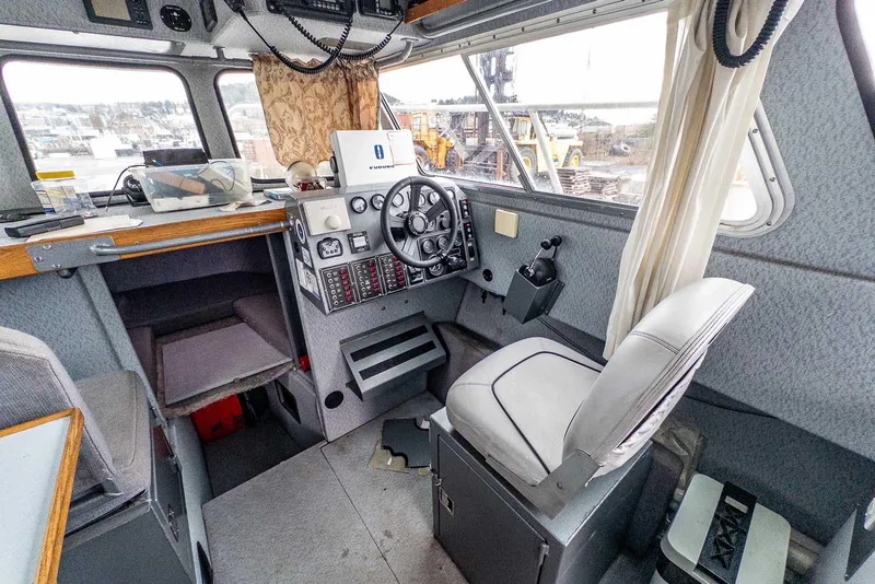 Slide: The Image of Interior of 2003 Lifetimer 3050 Pleasure Cabin boat with steering wheel and control panel. - 19