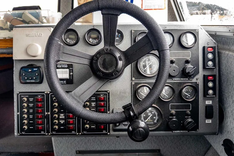 Slide: The Image of Control panel of a 2003 Lifetimer 3050 Pleasure Cabin boat with steering wheel and gauges. - 20