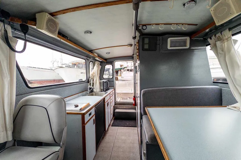 Slide: The Image of Interior of 2003 Lifetimer 3050 Pleasure Cabin boat with seating and kitchenette. - 23