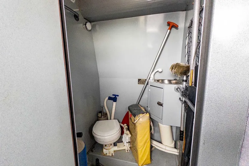 Slide: The Image of Compact bathroom in 2003 Lifetimer 3050 Pleasure Cabin boat, featuring toilet and sink. - 25