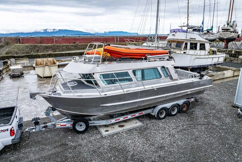 Slide: The Image of 2003 Lifetimer 3050 Pleasure Cabin boat on trailer, docked in a marina setting. - 4