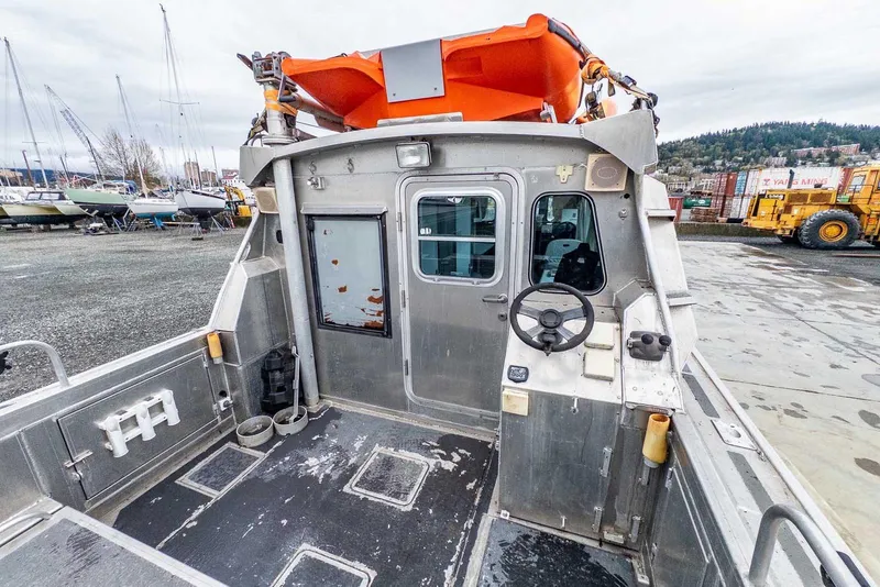 Slide: The Image of 2003 Lifetimer 3050 Pleasure Cabin boat interior with steering wheel and orange lifeboat. - 9