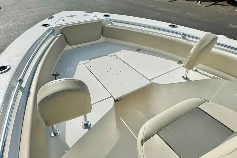 Slide: The Image of 2026 Key West 219 FS boat interior with cushioned seating and storage compartments. - 13