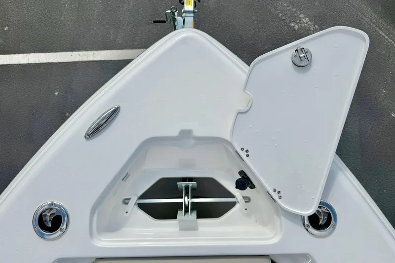 Slide: The Image of Bow storage compartment of 2026 Key West 219 FS boat, open lid, white finish. - 15