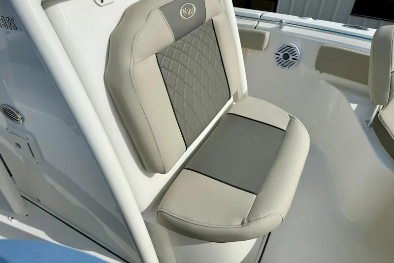 Slide: The Image of 2026 Key West 219 FS boat seat with beige and gray upholstery. - 17