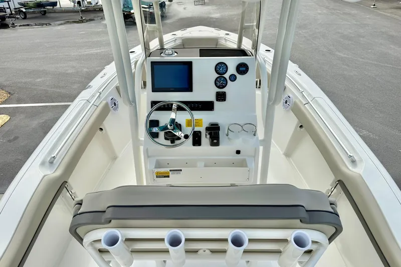 Slide: The Image of 2026 Key West 219 FS boat dashboard with steering wheel and gauges, docked in a marina. - 22