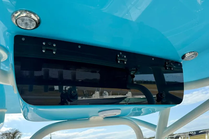 Slide: The Image of 2026 Key West 219 FS boat with blue canopy and mounted lights. - 23