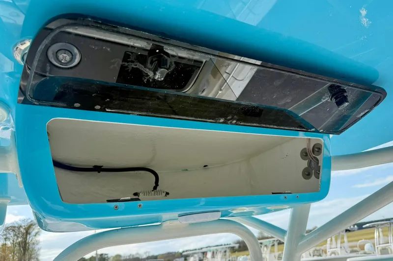 Slide: The Image of Open storage compartment on a 2026 Key West 219 FS boat, featuring a blue exterior. - 24