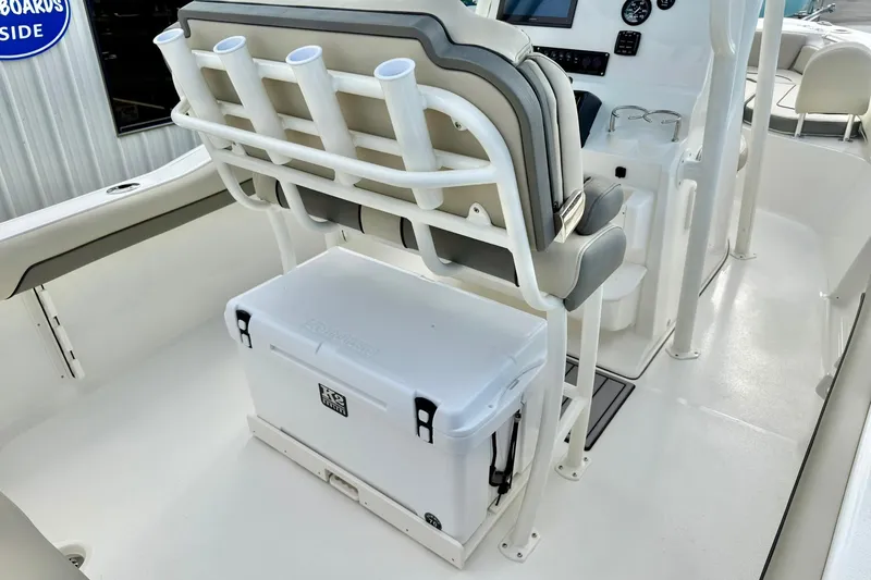 Slide: The Image of 2026 Key West 219 FS boat interior with rod holders and cooler storage. - 27