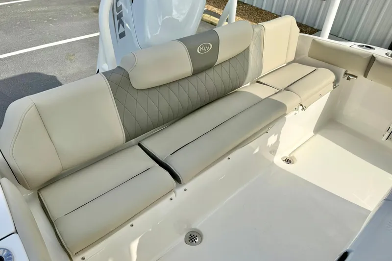 Slide: The Image of 2026 Key West 219 FS boat with beige cushioned seating and diamond-patterned backrest. - 29