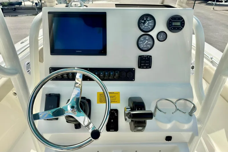 Slide: The Image of 2026 Key West 219 FS boat dashboard with steering wheel, gauges, and controls. - 3