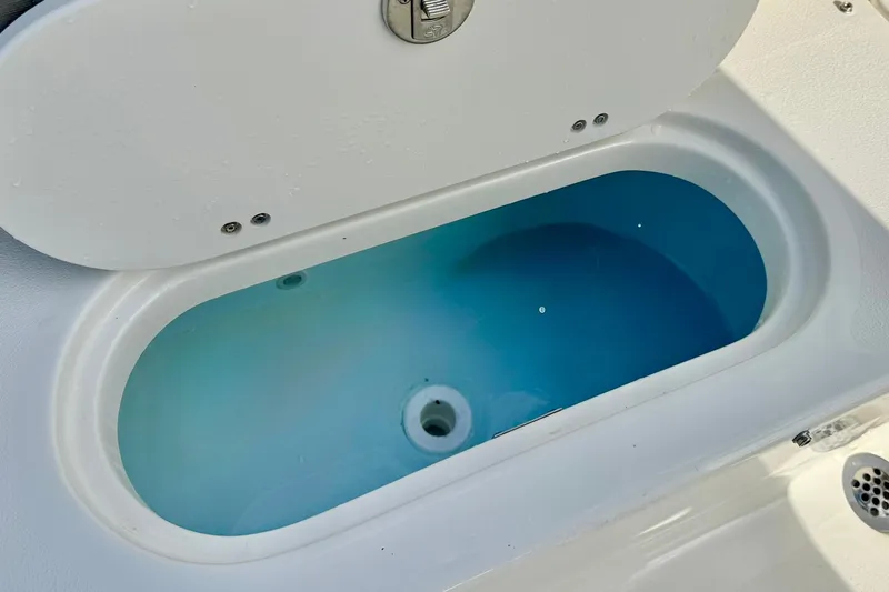 Slide: The Image of Livewell on 2026 Key West 219 FS boat, featuring a clean, blue interior. - 32