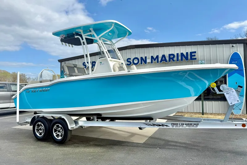 Slide: The Image of 2026 Key West 219 FS boat on trailer at Stroud & Son Marine dealership. - 6