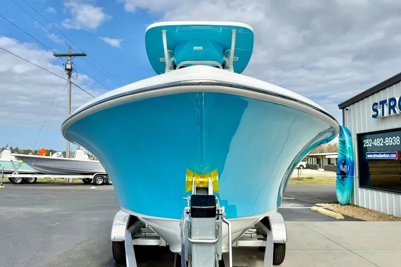 Slide: The Image of 2026 Key West 219 FS boat on trailer, vibrant blue hull, outdoor dealership setting. - 8