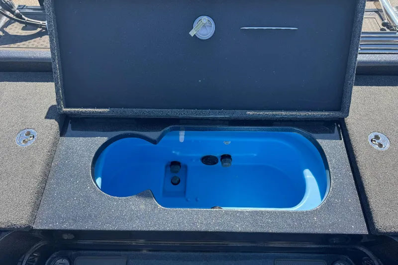 Slide: The Image of Open storage compartment on 2023 Nitro ZV20 boat, featuring a blue interior. - 11