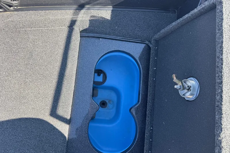 Slide: The Image of 2023 Nitro ZV20 boat interior with blue compartment and metal latch. - 15