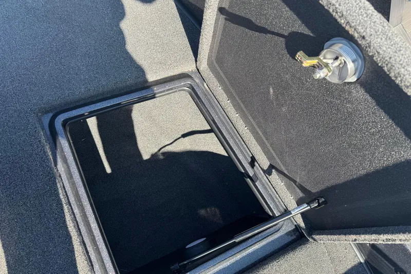 Slide: The Image of Open storage compartment on 2023 Nitro ZV20 boat with secure latch mechanism. - 16