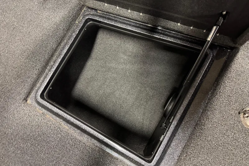 Slide: The Image of Open storage compartment in 2023 Nitro ZV20 boat, featuring carpeted interior. - 23