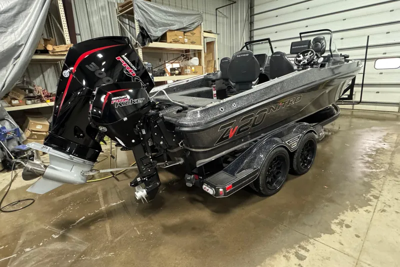 Slide: The Image of 2023 Nitro ZV20 boat with Mercury Pro Kicker engine in a garage setting. - 28