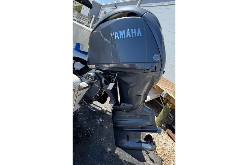 Slide: The Image of 2026 Key West 203 FS boat with Yamaha outboard motor, parked outdoors. - 11