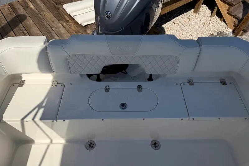 Slide: The Image of 2026 Key West 203 FS boat interior with cushioned seating and storage compartments. - 14