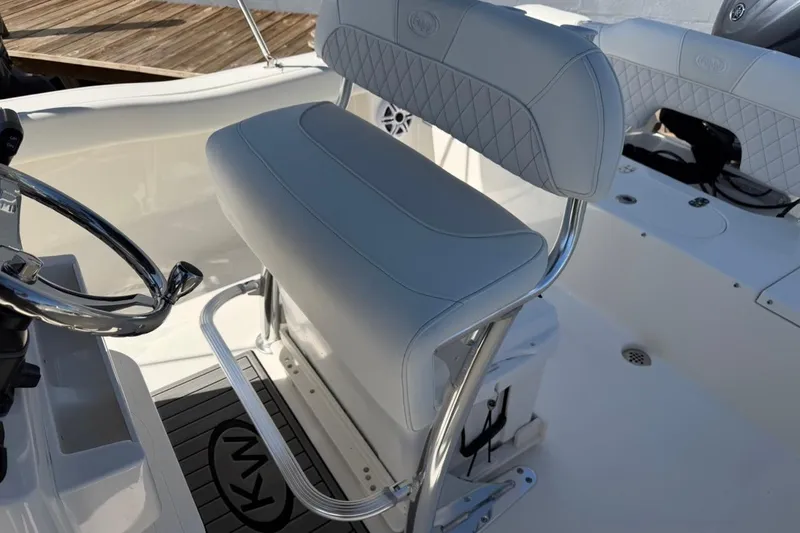 Slide: The Image of 2026 Key West 203 FS boat interior with cushioned seating and steering wheel. - 17