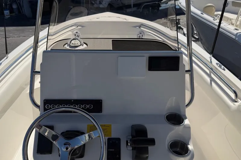 Slide: The Image of Steering console of 2026 Key West 203 FS boat with modern controls and cup holders. - 18