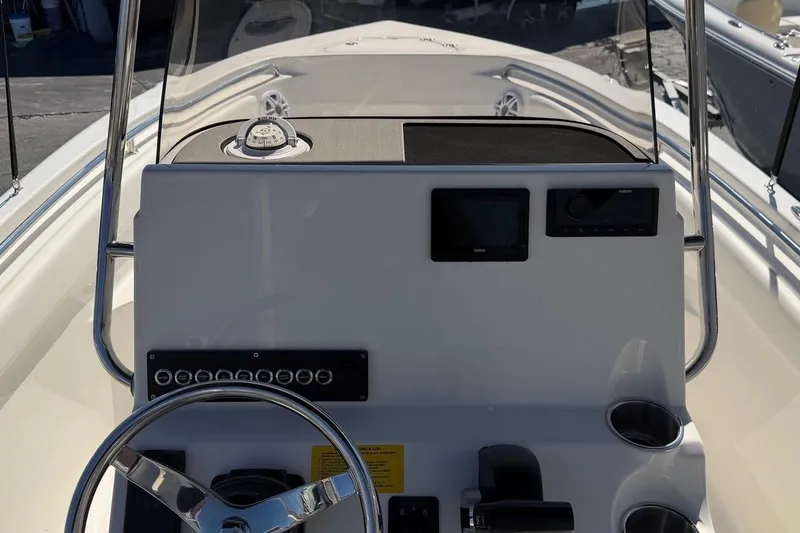 Slide: The Image of 2026 Key West 203 FS boat dashboard with steering wheel and navigation controls. - 19
