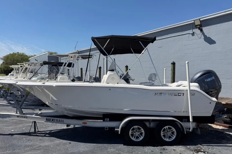 The Image of 2026 Key West 203 FS boat on trailer, featuring Yamaha engine, parked outdoors. - 2