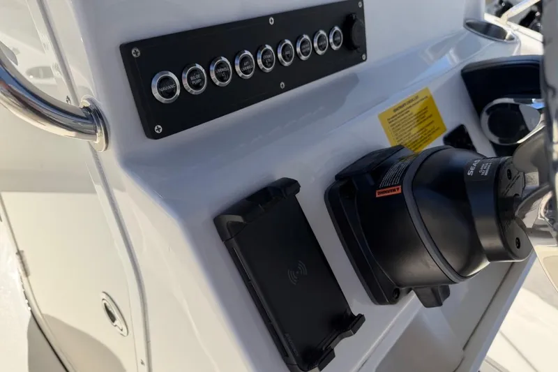 Slide: The Image of Control panel of 2026 Key West 203 FS boat with switches and steering wheel. - 20