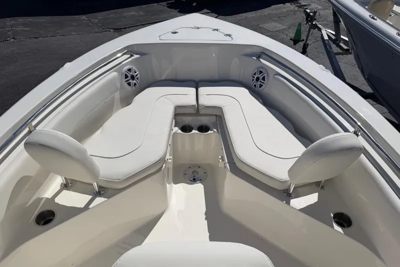 Slide: The Image of 2026 Key West 203 FS boat interior with white cushioned seating and cup holders. - 23
