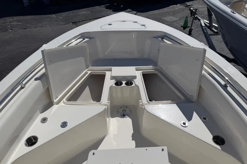 Slide: The Image of 2026 Key West 203 FS boat interior with open storage compartments and cup holders. - 25