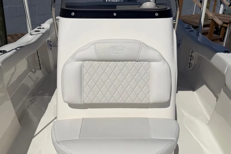 Slide: The Image of 2026 Key West 203 FS boat interior with white cushioned seating and diamond pattern design. - 27