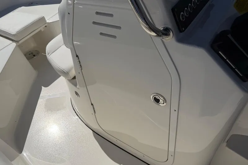 Slide: The Image of Interior view of a 2026 Key West 203 FS boat, featuring sleek white seating and console. - 30