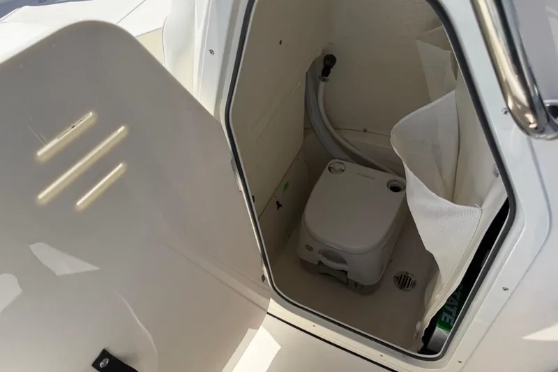 Slide: The Image of Interior of 2026 Key West 203 FS boat featuring compact marine toilet. - 31