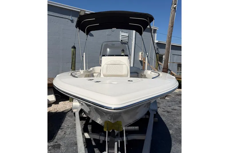 Slide: The Image of 2026 Key West 203 FS boat with canopy, parked outdoors on a sunny day. - 4