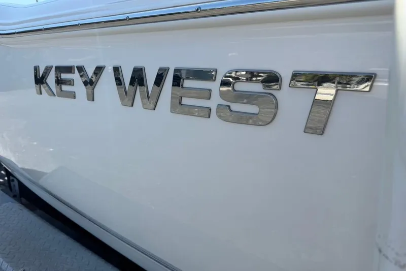 Slide: The Image of Key West 203 FS 2026 model boat with metallic logo on white surface. - 40