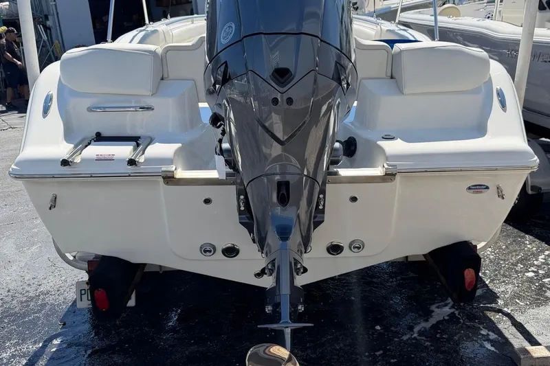 Slide: The Image of 2026 Key West 203 FS boat with powerful outboard motor, docked in marina. - 7