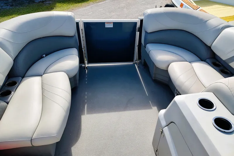 Slide: The Image of 2019 Sylvan Mirage Fish 8520 Party Fish boat interior with plush seating and cup holders. - 12
