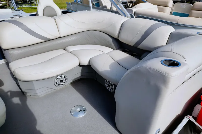 Slide: The Image of 2019 Sylvan Mirage Fish 8520 Party Fish boat interior with plush seating and cup holders. - 13