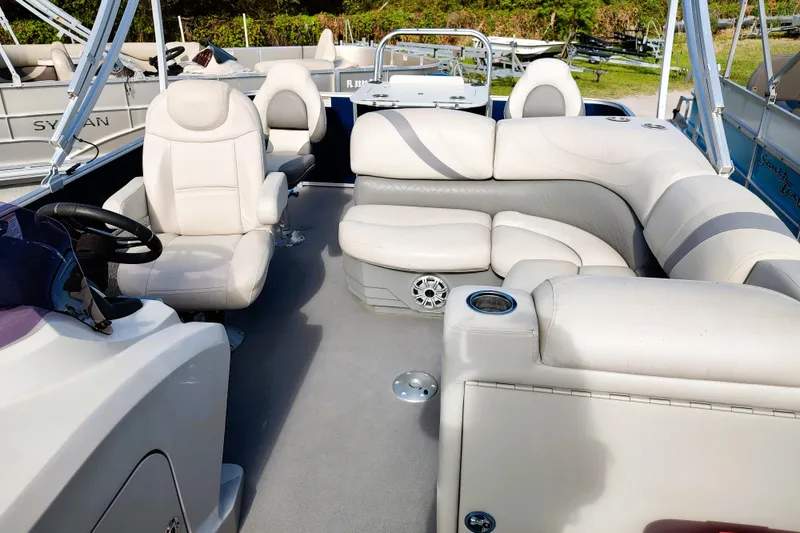 Slide: The Image of 2019 Sylvan Mirage Fish 8520 Party Fish boat interior with plush seating and steering console. - 14