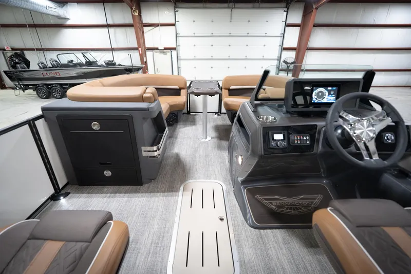 Slide: The Image of 2026 Bennington 22 MSB pontoon boat interior with modern dashboard and seating. - 20