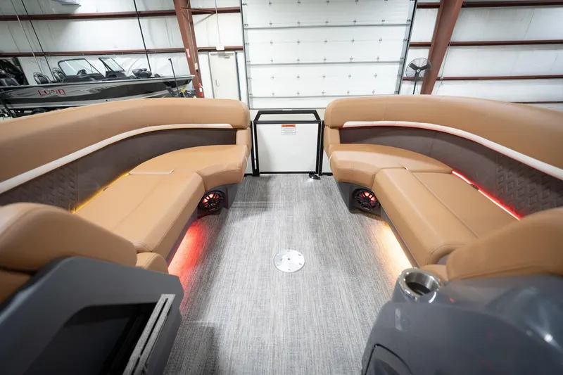 Slide: The Image of Luxurious interior of 2026 Bennington 22 MSB pontoon boat with plush seating and ambient lighting. - 22