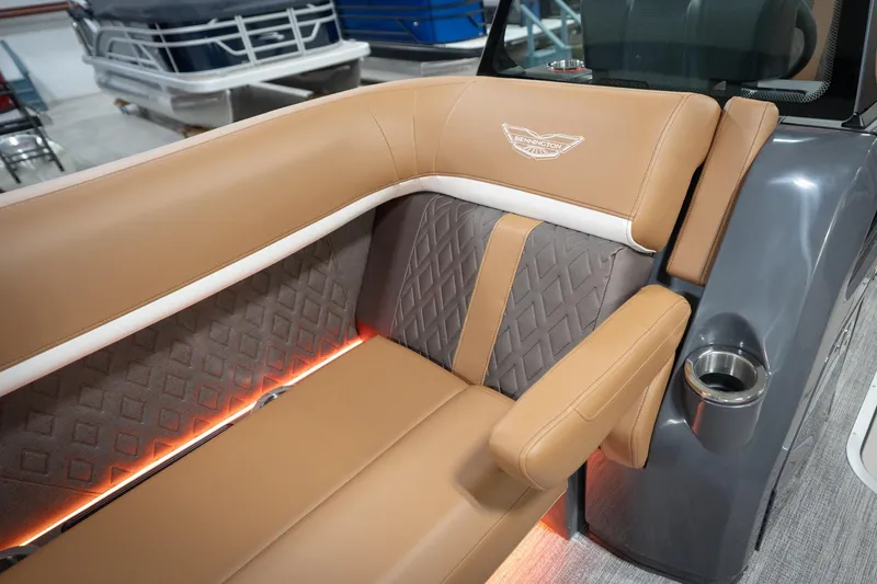 Slide: The Image of Luxurious seating on 2026 Bennington 22 MSB boat with tan upholstery and ambient lighting. - 25