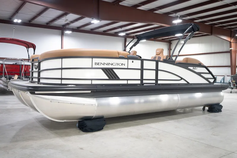 Slide: The Image of 2026 Bennington 22 MSB pontoon boat in a showroom, featuring sleek design and modern amenities. - 3