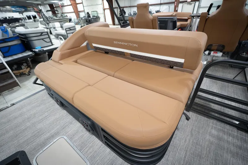 Slide: The Image of 2026 Bennington 22 MSB boat interior with tan seating in showroom. - 31