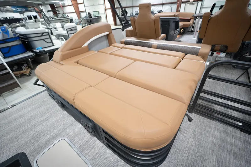 Slide: The Image of 2026 Bennington 22 MSB pontoon boat with tan leather seating in showroom. - 33