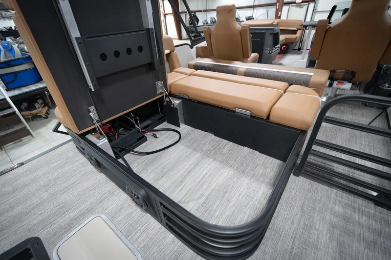Slide: The Image of 2026 Bennington 22 MSB interior with tan seating and storage compartments. - 36