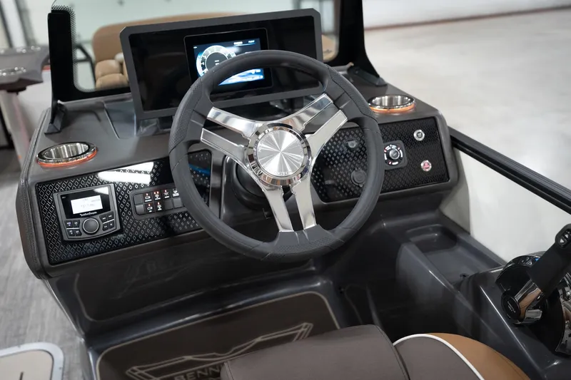Slide: The Image of 2026 Bennington 22 MSB boat dashboard with modern steering wheel and digital display. - 38